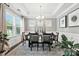 Bright dining room boasts natural light, tray ceilings, wainscoting, and a formal dining set with seating for six at 2377 Maple Grove Nw Ln, Concord, NC 28027