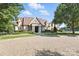 A clubhouse featuring a stone facade, a welcoming portico, and pristine landscaping at 2377 Maple Grove Nw Ln, Concord, NC 28027
