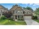 Beautiful two-story home featuring a well-manicured lawn, brick and stone accents, and an attached two-car garage at 2377 Maple Grove Nw Ln, Concord, NC 28027