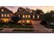 Exterior shot of a lovely two-story home at dusk with landscaped yard and attached two-car garage at 2377 Maple Grove Nw Ln, Concord, NC 28027