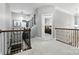 Bright hallway with iron railing and stylish decor leading to bedrooms at 2377 Maple Grove Nw Ln, Concord, NC 28027