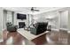 Cozy living room with a modern fireplace, accent wall, leather recliners, and a large screen television for entertainment at 2377 Maple Grove Nw Ln, Concord, NC 28027