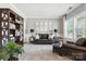 Comfortable living room featuring a stylish leather sofa set, bookshelf, neutral walls, and window with natural light at 2377 Maple Grove Nw Ln, Concord, NC 28027