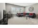 Living room with a large sectional, large windows, and a modern aesthetic at 2377 Maple Grove Nw Ln, Concord, NC 28027