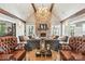 Comfortable lounge with exposed ceiling beams, stone fireplace and oversized seating at 2377 Maple Grove Nw Ln, Concord, NC 28027