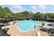 Aerial view of a community pool surrounded by lounge chairs, umbrellas and lush trees at 2377 Maple Grove Nw Ln, Concord, NC 28027