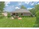 Expansive backyard view featuring a brick patio and lush lawn at 3003 Wedge Ct, Matthews, NC 28104