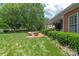 Brick home featuring a backyard patio with seating and beautiful lawn at 3003 Wedge Ct, Matthews, NC 28104