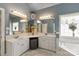 This primary bathroom has dual sinks, tub, and ample lighting at 3003 Wedge Ct, Matthews, NC 28104