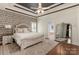 Spacious primary bedroom features a tray ceiling, en suite bathroom, and stylish accents at 3003 Wedge Ct, Matthews, NC 28104