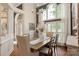 Bright dining room with hardwood floors, large windows, white drapes, and an elegant chandelier at 3003 Wedge Ct, Matthews, NC 28104