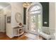 Elegant foyer featuring a hardwood floor, chandelier, decorative mirror and ample natural light from the front door at 3003 Wedge Ct, Matthews, NC 28104