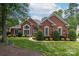Charming brick home with manicured lawn and mature landscaping creating an inviting curb appeal at 3003 Wedge Ct, Matthews, NC 28104