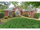 Beautiful brick home with a well-maintained lawn, attractive landscaping, and inviting walkway to front door at 3003 Wedge Ct, Matthews, NC 28104