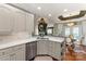 Open concept kitchen with white cabinets, stone countertops, stainless steel appliances, and a view to the living room at 3003 Wedge Ct, Matthews, NC 28104