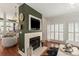 Stylish living room featuring a fireplace, hardwood floors, and natural light from the nearby windows at 3003 Wedge Ct, Matthews, NC 28104