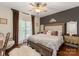 This main bedroom features dark accent wall, hardwood floors, and a large window at 3003 Wedge Ct, Matthews, NC 28104