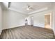 Bright bedroom with neutral walls, tray ceiling, and doorway to kitchen and bath at 3248 Ferguson Long Rd, York, SC 29745