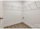 Walk-in closet with white wire shelving and neutral walls and wood-look flooring at 3248 Ferguson Long Rd, York, SC 29745