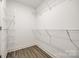 Walk-in closet with white walls, wire shelving and wood-look vinyl flooring at 3248 Ferguson Long Rd, York, SC 29745