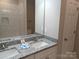 Renovated bathroom featuring double vanity with granite countertops and large mirror at 372 Lippard Farm Rd, Statesville, NC 28625