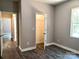A bedroom featuring wood-look flooring, closet, gray walls, and an entrance to hallway at 372 Lippard Farm Rd, Statesville, NC 28625
