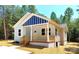 Charming single-Gathering home with a quaint porch and light blue siding in a wooded area at 372 Lippard Farm Rd, Statesville, NC 28625