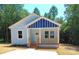 Lovely single-story home with a light blue exterior and inviting front porch at 372 Lippard Farm Rd, Statesville, NC 28625