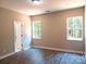 Spacious main bedroom with two windows, neutral walls, and luxury vinyl flooring at 372 Lippard Farm Rd, Statesville, NC 28625
