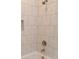 Shower and bathtub with white marble-style tiling and soap nook at 372 Lippard Farm Rd, Statesville, NC 28625