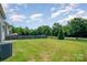 Expansive backyard with lush green grass and a wooden fence, perfect for outdoor activities and relaxation at 3816 Ernie Dr, Charlotte, NC 28269