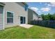 Lush backyard featuring a small patio, green lawn, and a wooden fence, ideal for outdoor living and entertaining at 3816 Ernie Dr, Charlotte, NC 28269