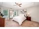 Inviting bedroom with a tray ceiling, large mirror, and an abundance of natural light at 3816 Ernie Dr, Charlotte, NC 28269