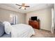 Comfortable bedroom featuring a ceiling fan, large closet, and an adjacent ensuite bathroom at 3816 Ernie Dr, Charlotte, NC 28269