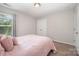 Well-lit bedroom featuring a double closet and a large window for natural light at 3816 Ernie Dr, Charlotte, NC 28269