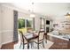 Dining area with a table, chairs, and natural light streaming through the sliding glass doors at 3816 Ernie Dr, Charlotte, NC 28269