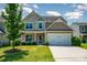 Charming two-story home with landscaped yard, mature trees, and attached two-car garage at 3816 Ernie Dr, Charlotte, NC 28269