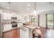 Bright kitchen with granite countertops, stainless steel appliances, and a breakfast bar with seating at 3816 Ernie Dr, Charlotte, NC 28269