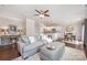 Comfortable living room with a plush sofa, ottoman, hardwood floors, and a view of the open kitchen at 3816 Ernie Dr, Charlotte, NC 28269