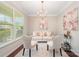 Cozy living room featuring a plush sofa, elegant chairs, and ample natural light from the large window at 3816 Ernie Dr, Charlotte, NC 28269