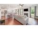 Open-concept living room featuring a fireplace, hardwood floors, and seamless flow to the kitchen at 3816 Ernie Dr, Charlotte, NC 28269