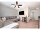 Cozy living room featuring a comfortable gray sofa and a ceiling fan for added comfort at 3816 Ernie Dr, Charlotte, NC 28269