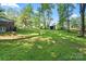 Expansive backyard with lush lawn, mature trees, shed, and plenty of room for outdoor activities at 4322 Greenhaven Ln, Gastonia, NC 28056