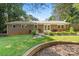 Large backyard with well-maintained lawn, mature trees, and a brick ranch-style home at 4322 Greenhaven Ln, Gastonia, NC 28056