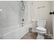 Bathroom featuring modern toilet, bathtub and tiled shower with neutral decor at 4322 Greenhaven Ln, Gastonia, NC 28056