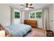 Bedroom features large windows for natural light, wood floors, and a decorative ceiling fan at 4322 Greenhaven Ln, Gastonia, NC 28056