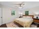 This well-lit bedroom has two windows, hardwood floors, and a ceiling fan at 4322 Greenhaven Ln, Gastonia, NC 28056