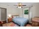 Bedroom featuring large windows for natural light, wood floors, and a ceiling fan at 4322 Greenhaven Ln, Gastonia, NC 28056