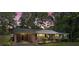 Inviting brick home with a carport against a twilight sky, complemented by verdant trees and fresh landscaping at 4322 Greenhaven Ln, Gastonia, NC 28056