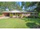 Charming brick home with a well-manicured lawn and mature trees creating a welcoming curb appeal at 4322 Greenhaven Ln, Gastonia, NC 28056